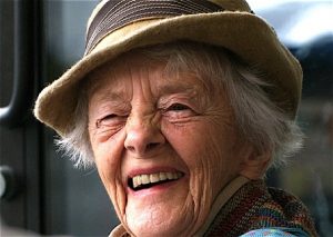 Old woman with white hair and a beautiful smile